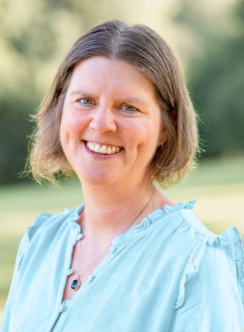 Amy McCrea, GI dietitian, smiling outdoors in a light blue blouse